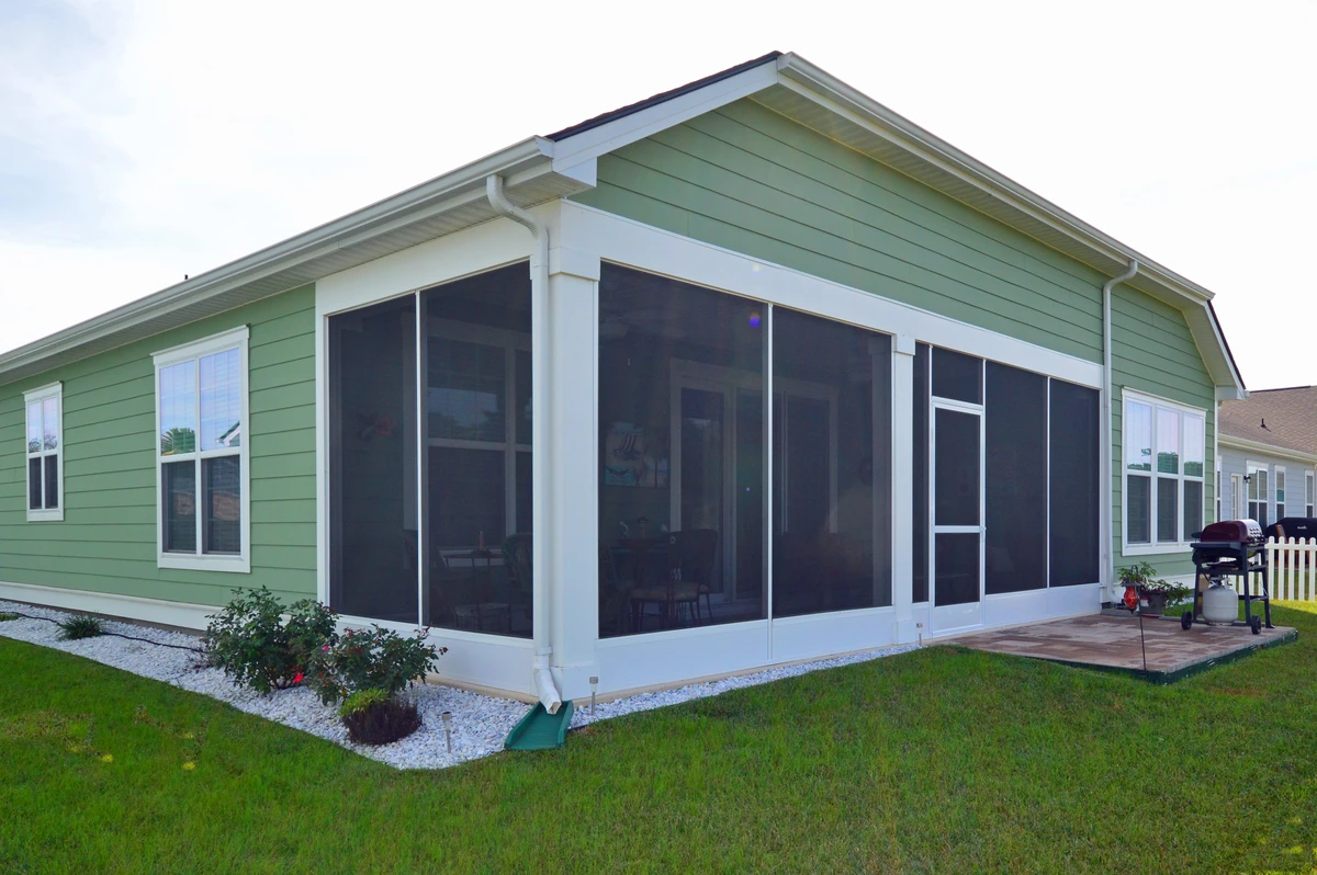 Remodeled screen room interior with updated finishes and large windows