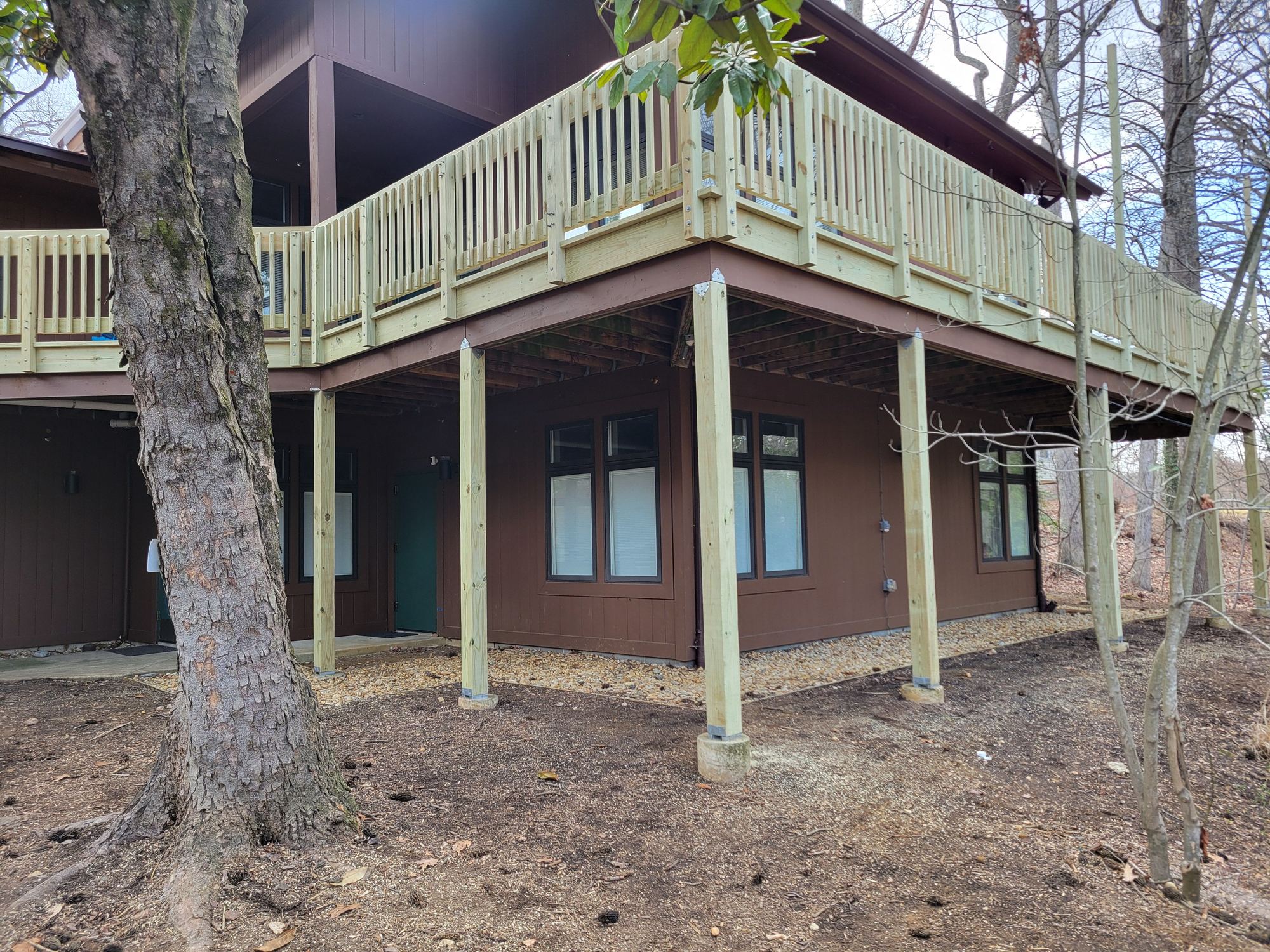 Rebuilt elevated deck with new pressure-treated framing, support posts and railings